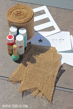 some burlap and paint are sitting on the ground