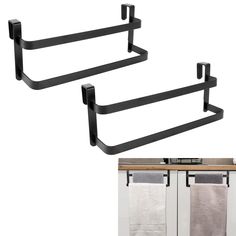 two black metal towel racks with towels hanging on them