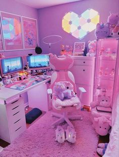 a bedroom with pink walls and lots of stuffed animals on the floor in front of two computer desks