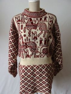 an old sweater with elephants and people on it