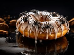 a donut covered in white icing and spider webs on top of it