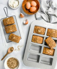 muffins and other ingredients on a white table with an egg in a bowl