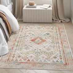 a bedroom with a large rug on the floor and a bed in front of it