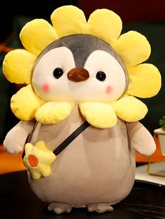 a stuffed animal that looks like a hedgehog with yellow flowers on its head and tail