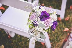 a bouquet of flowers sitting on top of a white chair next to an empty seat