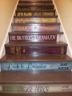 a set of stairs made out of books with the names of authors painted on them