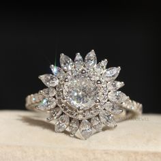 a diamond ring sitting on top of a cushion