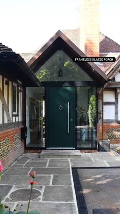 a green door in front of a brick house