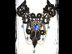 From the GLAMMED UP Collection |  Up the drama and turn heads in any room you walk into with this stunning Black Lace Necklace with Blue Glass Cabochon and Beads.  Contact me for custom orders (colour, length, crystals, cabochons, etc.)  This is a one of a kind oversize necklace for the woman who Dares to be Different.  Dimensions and Features: *2-inch extension *22 inches long (end-to-end) *Bronze setting *Lead- and nickel-safe *Black lace appliqué *Blue glass beads (can be round or tear-drop) Black Fantasy Necklaces For Parties, Fantasy Style Adjustable Black Necklace, Fantasy Style Black Necklace, Formal Blue Cabochon Necklace, Black Adjustable Fantasy Necklace, Handmade Victorian Blue Necklaces, Handmade Gothic Blue Necklace, Ornate Blue Necklace With Intricate Design, Handmade Blue Gothic Necklace