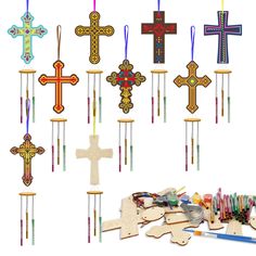 wooden crosses and crochet hooks are displayed on a white background with colored crayons