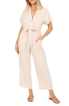 A defining tie tethers the waist of this lightweight linen jumpsuit designed with abbreviated sleeves and cropped legs. Front button closure V-neck Short sleeves Removable belt Side patch pockets 100% linen Hand wash, dry flat Imported Petal And Pup, Night Tops, Short Loungewear, Designer Jumpsuits, Linen Jumpsuit, Exclusive Clothing, Clothing Details, Strapless Tops, Dresses By Length