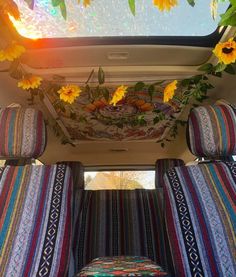 the sunflowers are growing on the ceiling in the back of a van with seats