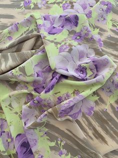 The flowers are so delicate and joyful on this unique bold floral printed silk crepe de chine designer fashion fabric in lavender, lilac, lime, and tan. SKU: 8076 Content: 100% Silk Color: Lavender / Lilac / Lime / Tan Width: 45 inches This fabric is a last cut and no longer in production. Once sold out, we are unable to get more.