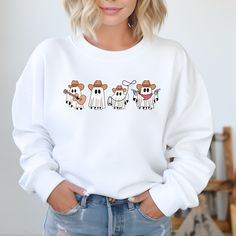 Stay cozy and stylish in our Cowboy Ghosts Sweatshirt. This western-inspired sweater features cute ghost designs that will add a playful touch to your wardrobe. Get ready to turn heads and keep warm in our unique and fun sweatshirt. White Fun Sweater For Fall, Fun White Sweater For Fall, White Cartoon Print Sweater For Fall, White Cartoon Print Sweatshirt For Fall, White Sweatshirt With Character Print For Fall, Fall Character Print Relaxed Fit Sweatshirt, Ghost Design, Fun Sweatshirts, Cute Ghost