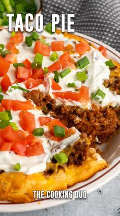 the taco pie is topped with sour cream and tomatoes