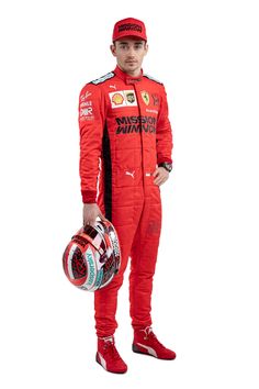 a man in a racing suit holding a helmet