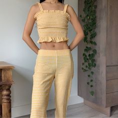 Callipygian Yellow Gingham Ruffle Shirred Crop Top & Pants Two Piece Set The Cutest Set! The Fabric Is Not Just A Plain Flat Yellow Gingham Print, It Has Some Crinkle Details Throughout Which Makes Is Sooo Cute And Refined Top Is Xs, Has Elasticized Shirred Panel All Around So It Hugs Your Body Super Well And Has Lots Of Stretch; Pants Are A Size 2, It’s Not My Size So It’s A Bit Loose On Me, Shown On A 23” Waist; Measurements Waist: 14 Inch Flat Across, Fits Low Waist Inseam: 24 1/2 Inch Bought Fitted Plaid Sets For Spring, Fitted Gingham Sets For Spring, Casual Summer Plaid Sets, Casual Plaid Sets For Summer, Casual Plaid Summer Sets, Summer Plaid Pants For Loungewear, Summer Plaid Loungewear Pants, Spring Gingham Sets With Ruffles, Casual Ruffled Bottoms For Picnic