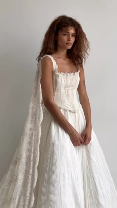 a woman in a white wedding dress and veil