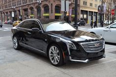 a black car parked on the side of the road