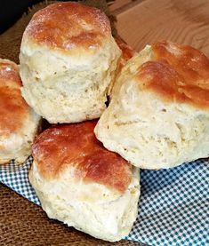 four biscuits are stacked on top of each other in a pile with a checkered cloth