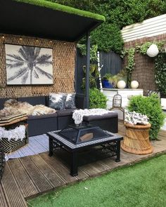 an outdoor living area with wicker furniture and plants