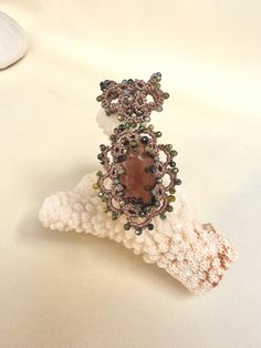 a brooch sitting on top of a white piece of cloth