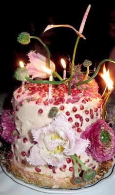 a cake with flowers and candles on it