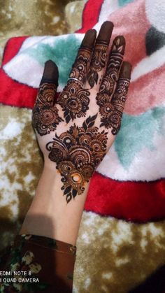 a woman's hand with henna on it