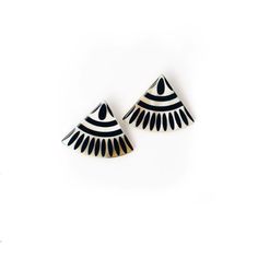 pair of black and white earrings with geometric design on the top, against a white background