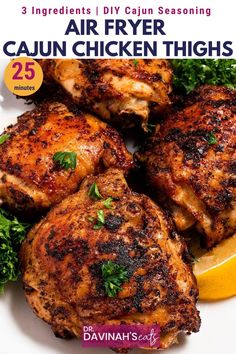 the front cover of an air fryer cajun chicken thighs recipe with lemon wedges and parsley