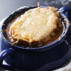 a blue bowl filled with food on top of a table