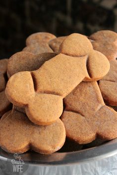 several heart shaped cookies are stacked on top of each other in a metal bowl,