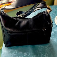 Adorable Black Leather Bag. Silver Metal Detailing. Perfect Condition. Never Used. Good Thick Quality Leather. It Has A Zipper On The Back And A Flap In The Front With A Snap Closure. There Is Also A Small Pocket With A Zipper. The Inside Has A Generous Inside Zippered Pocket And A Place For Cards Inside. Has An Adjustable Shoulder Strap Elegant Black Hobo Bag With Snap Closure, Black Hobo Bag With Snap Closure For Travel, Black Leather Bag, Black Leather Satchel, Bag Silver, Black Leather Bags, Leather Satchel, Snap Closure, Leather Bag