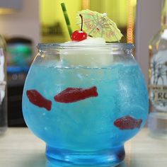 a drink in a fish bowl with a cherry on top