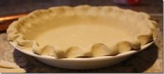 an uncooked pie crust in a white bowl