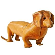 a wooden toy dachshund dog on a white background