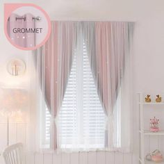 a white bed sitting next to a window covered in pink curtains