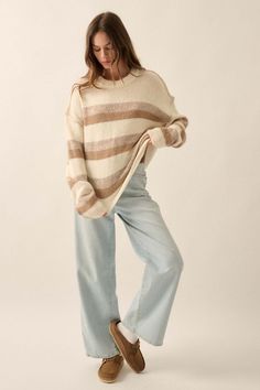 Striped knit sweater. Exposed seams with decorative stitching. Round neckline. Long sleeves. Drop shoulder. Rib knit neckline, cuffs, and hem. Loose fit. 45% Polyester, 45% Nylon, 10% Wool. Imported. Designed in LA. Model wears size S. Neutral Fall Sweater With Ribbed Cuffs, Neutral Crew Neck Knit Top For Fall, Neutral Knit Top For Fall, Fall Neutral Soft Knit Top, Casual Cream Sweater With Ribbed Neckline, Striped Knit Sweater, Exposed Seams, Decorative Stitching, Striped Knit