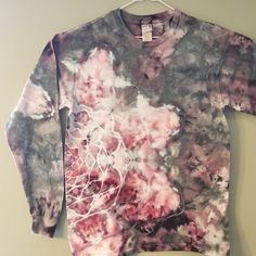 a tie dye shirt hanging on a wall