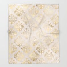 a gold and white wall hanging on the side of a wall