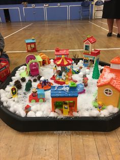 an indoor play area with toys and snow