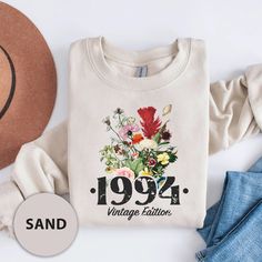 Stay warm and stylish with our Gildan sweatshirt featuring the elegant "1994 Vintage Edition" floral design.  Perfect for 90s kids who want to celebrate their vintage year, this sweatshirt offers both comfort and a unique design. Whether you're looking for a thoughtful birthday gift or a cozy piece of nostalgia, this sweatshirt is a must-have for every 1994 edition. ♦️ HOW TO ORDER: 1️⃣To begin, select the desired product type and size from the drop-down menu. 2️⃣Next, choose the primary color a Vintage Letter Print Sweatshirt For Spring, Casual Winter Birthday Sweatshirt, Fall Birthday Sweatshirt With Graphic Print, Graphic Print Sweatshirt For Birthday In Fall, Casual Graphic Print Sweatshirt For Birthday, Vintage Graphic Print Sweatshirt For Spring, Vintage Crew Neck Top As Gift, 90s Birthday, Gildan Sweatshirt