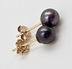 Vintage Mikimoto 14k Gold and Black South Sea Iridescent Pearl Stud Earrings Measurements: .6"L x .25"R (1.52cm x .64cm) Markings: M Logo 14K on stems Weight: .8g Stunning set of Black South Sea pearl and 14k yellow gold post earrings from the iconic Mikimoto. Pearls are approximately 5mm round. Overall earrings are in excellent condition with very light wear. You can always identify Mikimoto jewelry by our trademark, which is either the outline of an oyster or the Mikimoto name engraved on every piece. This engraved mark can be found in the following locations: Earrings: on post, earring nuts or back of earrings Model is a life-size representation Found in 1893 by Kokichi Mikimoto he successfully created the world's first cultured pearls. Ever since then, Mikimoto has been seeking to harn Mikimoto Jewelry, Iridescent Pearl, South Seas, South Sea Pearls, Pearl Stud Earrings, Pearl Studs, Cultured Pearls, Jewelry Earrings Studs, Post Earrings