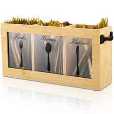 a wooden box filled with forks and spoons next to each other on top of a white surface