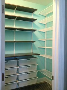 an empty closet with shelves and bins