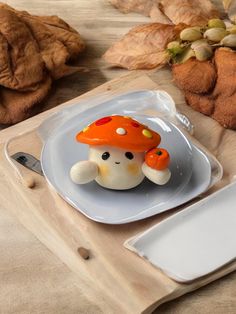 a plate with an orange mushroom on it