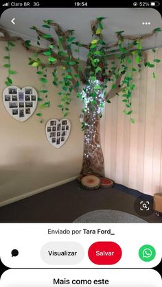 an image of a tree with green leaves on the branches and hearts hanging from it