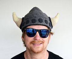 a man wearing sunglasses and a knitted hat with horns