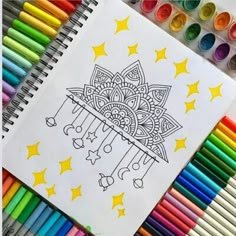 a coloring book surrounded by crayons and markers