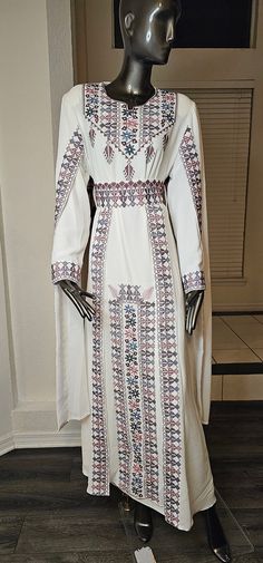 An Elegant White Jordanian Palestinian Thobe Dress Kaftan Abaya with Purple, Pink and light blue Embroidery tatreez from the front, over skirt on the waist and embroidered cape on both shoulders comes with a belt Embroidery Details are on the front, the shoulders cape and belt as shown in the pictures & Video. Comes with a lining dress (Long sleeves white under dress) Modern Design, Very high quality Materials. always the product in real much prettier than the picture. - Color : White & Purple, pink and light blue embroidery Size 3((Fits Medium & Large Size)) Bust : 44 inches Shoulders : 18-20 inches Length : 58 inches. Half Sleeves  Long Sleeve Under Dress - Condition : NEW - Price : 260$ - Shipping : Free Shipping with USPS Priority Mail Shipping  - No Returns & No Exchange Accepted plea Embroidery Abaya Design, Long Sleeve Under Dress, Jordanian Dress, Embroidery Abaya, Luxury Embroidery, Abaya Design, Kaftan Abaya, Dress Kaftan, Pink Embroidery